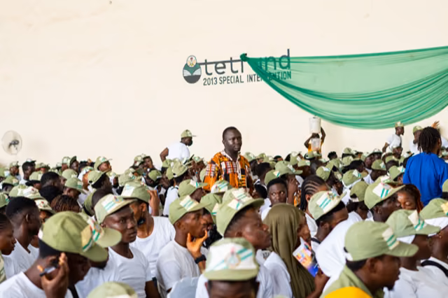 The Pody speaker stands among a packed hall of corps members