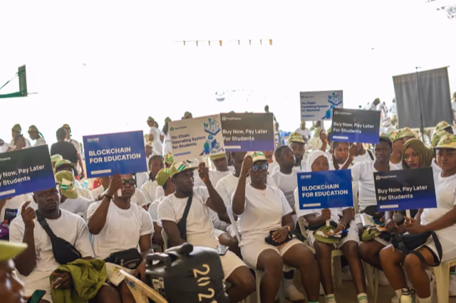 Corps members hold up Pody, Open Campus and EDU Chain boards together